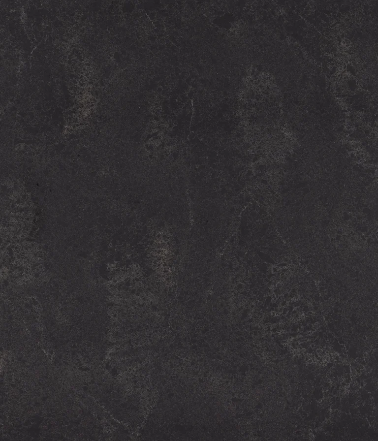 Dark textured surface with subtle gray and black marbling patterns.